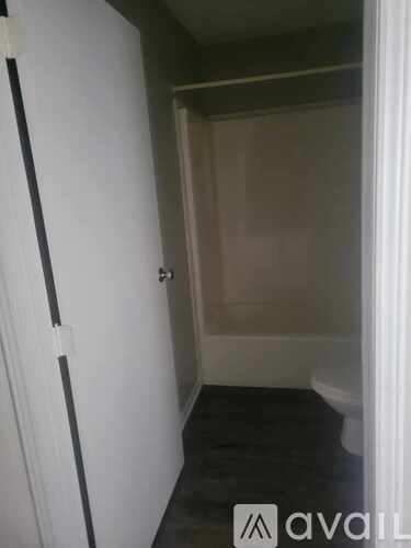 A small bathroom with a toilet and a shower stall.