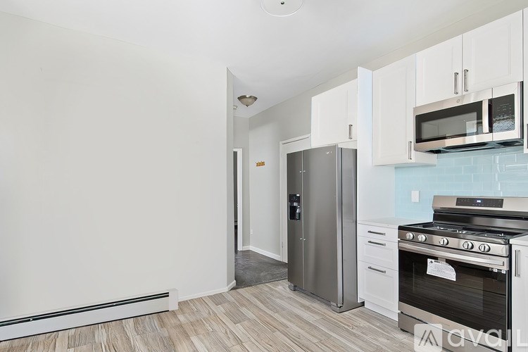 A kitchen with a stove, oven, and refrigerator.