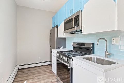 A kitchen with a stove, oven, and sink.