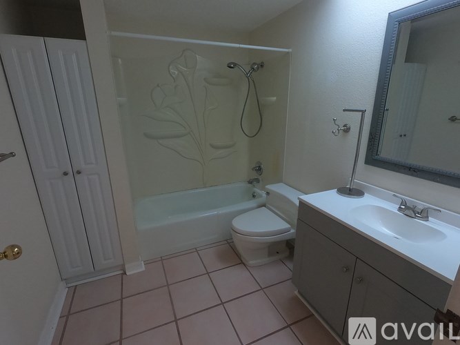 A bathroom with a toilet, sink, and bathtub.