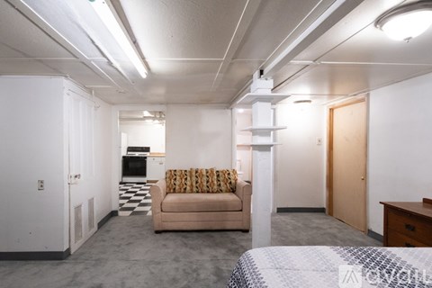 A living room with a couch and a bed.