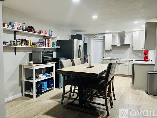 A kitchen with a table and chairs in the middle of the room.