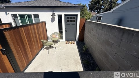 A backyard with a wooden fence and a patio table.