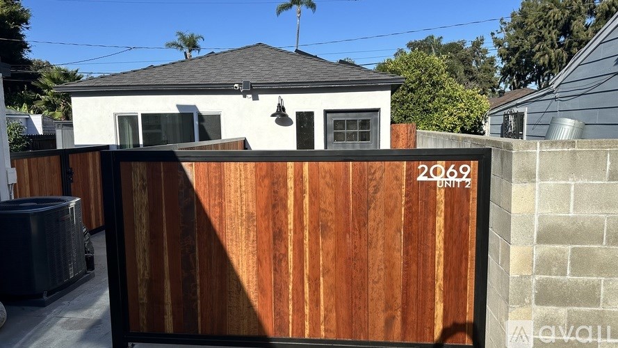 A wooden fence with the number 2069 on it.