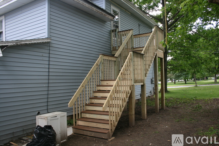 A wooden staircase outside a house.