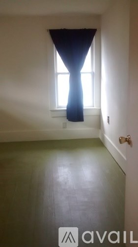 A room with a window and a closed door.