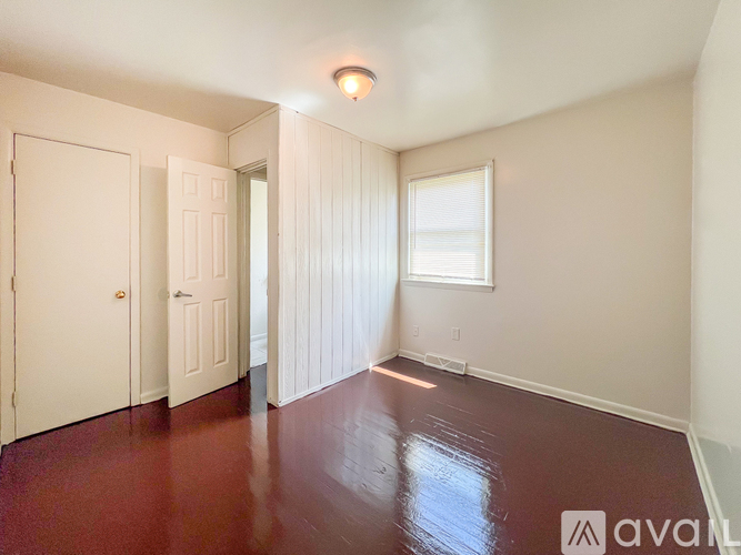 A room with a red floor and white walls.