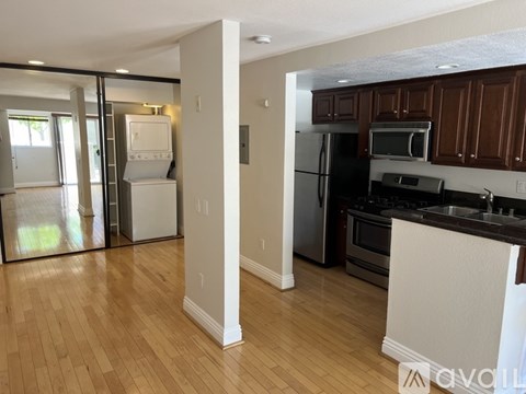 A kitchen with wooden cabinets and a white island.