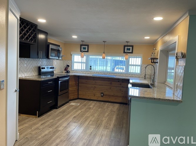 A kitchen with wooden floors and a countertop.