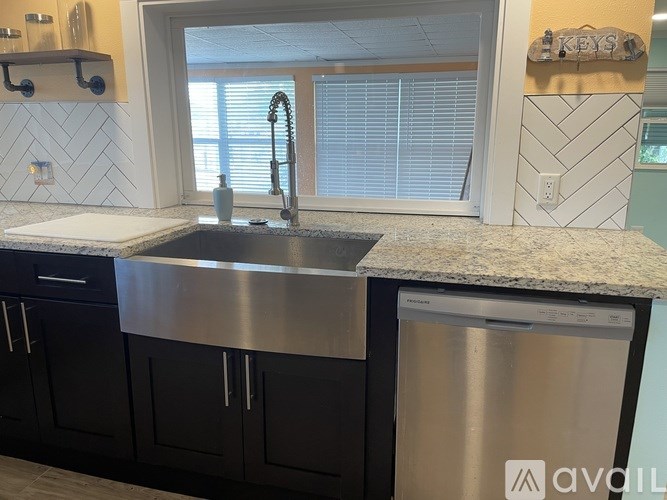 A kitchen with a sink and a window.