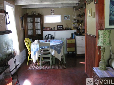 A kitchen with a table and chairs.