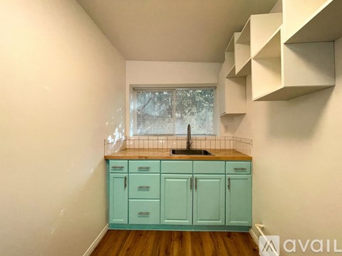 A kitchen with a sink and cabinets.