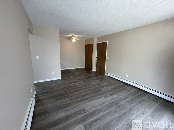A room with wooden floors and a white ceiling.