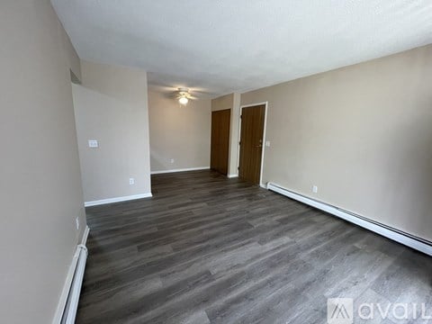 A room with wooden floors and a white ceiling.