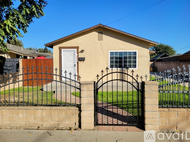 A house with a black gate and a white door.