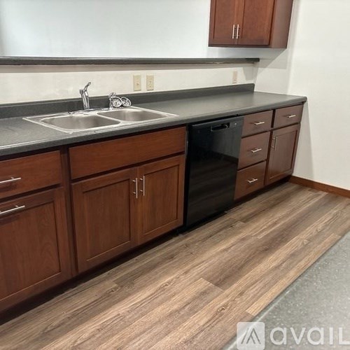 A kitchen with wooden cabinets and a grey countertop.