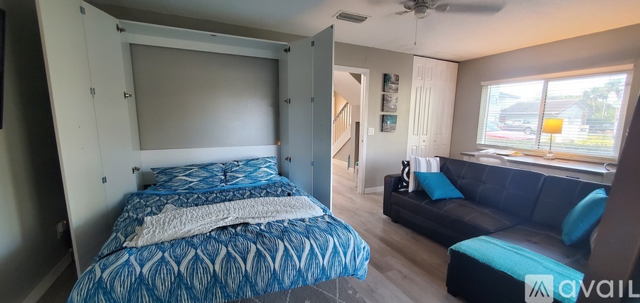 A bedroom with a bed and a couch.