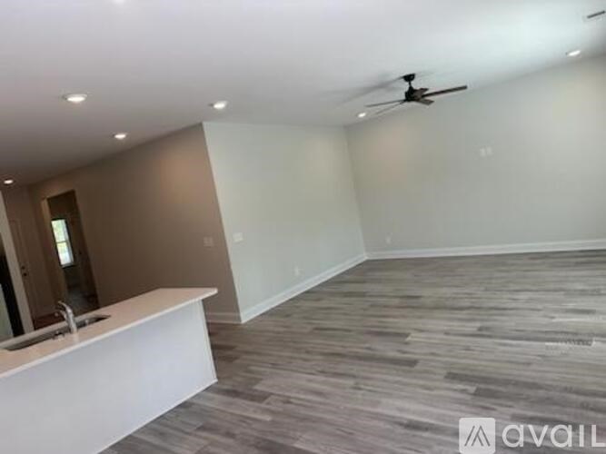 A room with a white counter and a ceiling fan.