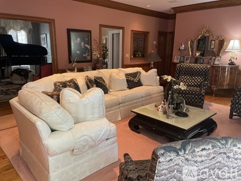 A living room with a white couch and a black coffee table.