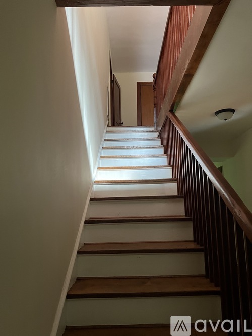A staircase with wooden steps and a railing.