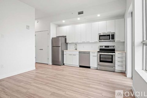 A kitchen with white cabinets and stainless steel appliances.
