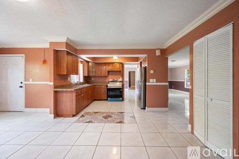 A kitchen with brown cabinets and a white countertop.