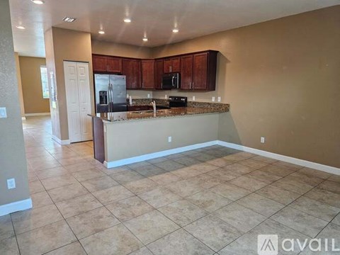 A kitchen with brown cabinets and a countertop is available for rent.