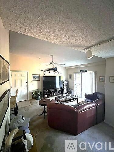 A living room with a red couch and a television.