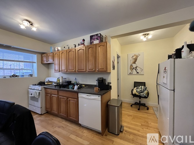 A kitchen with wooden cabinets and a white fridge.