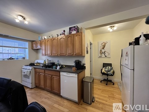 A kitchen with wooden cabinets and a white fridge.