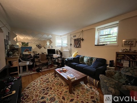 A living room with a couch, chair, and coffee table.