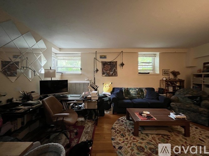 A living room with a couch, chair, and coffee table.