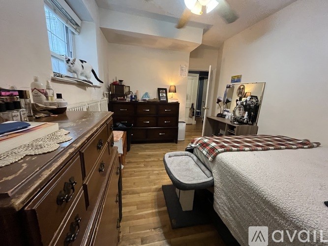 A room with a bed, a desk, and a chair.