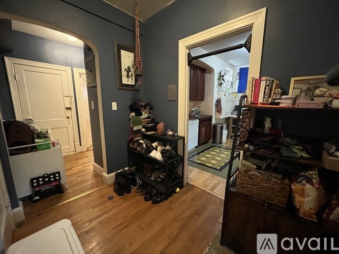 A room with a washing machine and a basket of shoes.