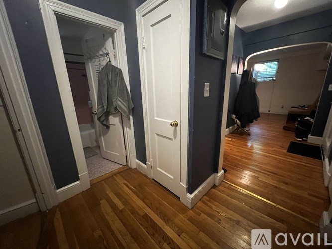 A room with a white door and a mirror on the wall.