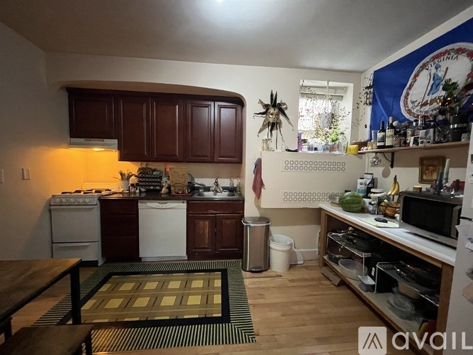 A kitchen with wooden cabinets and a white stove top oven.