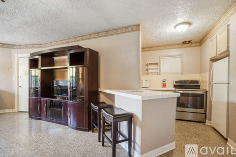 A kitchen with a white counter top and a white refrigerator.