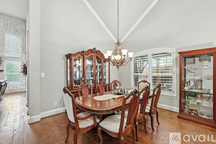 A dining room with a wooden table and chairs.