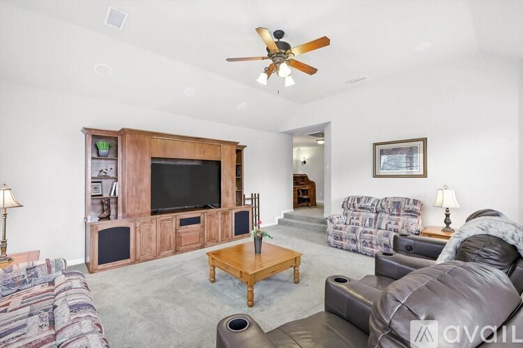 A living room with a television, couches, and a coffee table.