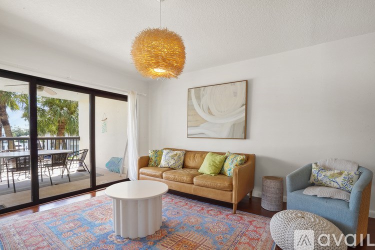 A living room with a sofa, a table, and a chair.