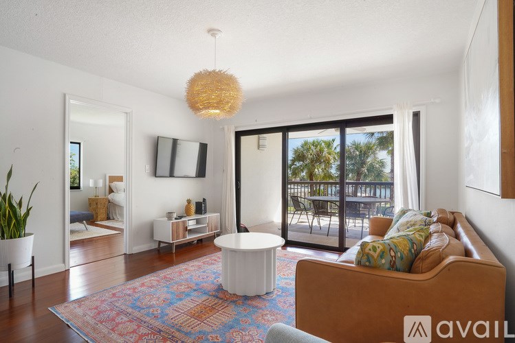 A living room with a brown couch and a white coffee table.