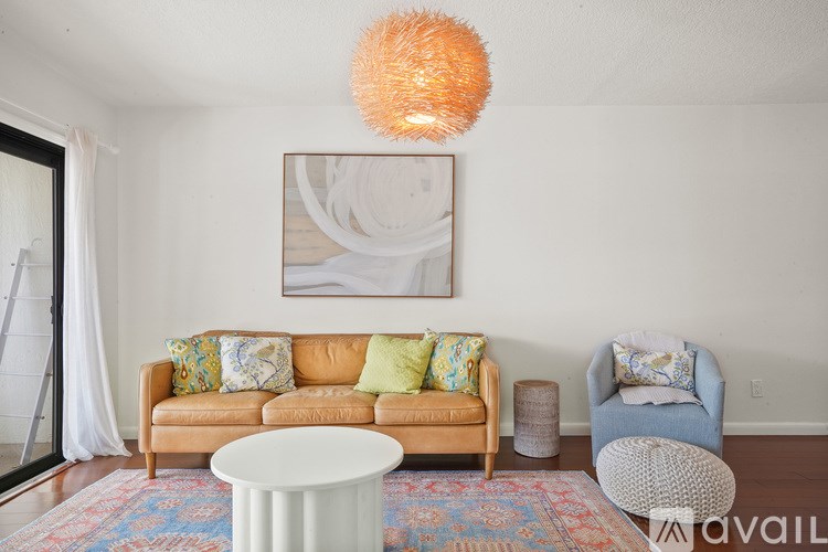 A living room with a couch, a chair, and a table.
