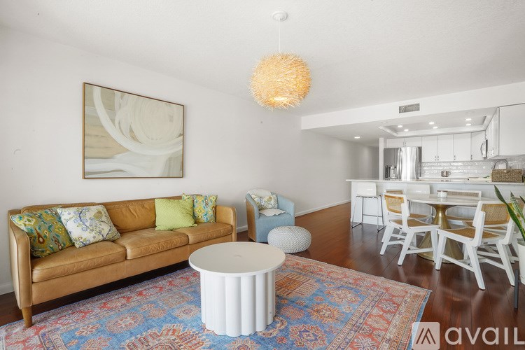 A living room with a brown couch and a white coffee table.