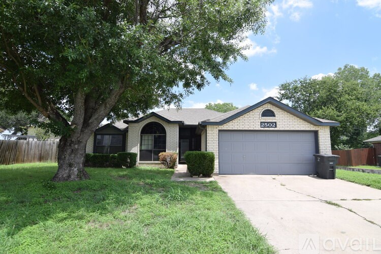A house with a black car parked in front.