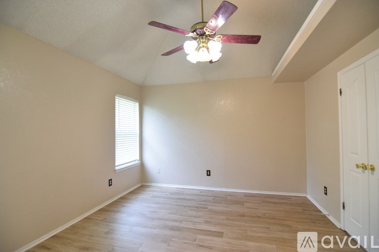 A bathroom with a vanity and a mirror with lights above it.