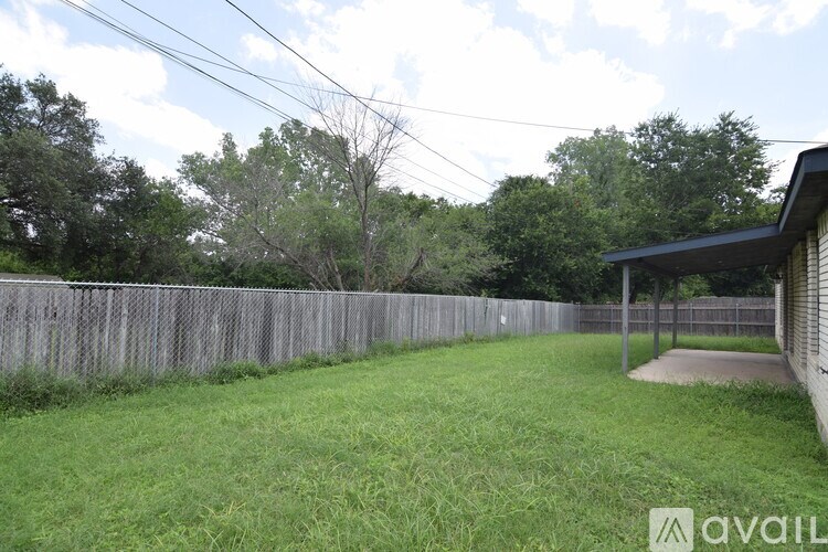 A backyard with a wooden fence and a small shed.