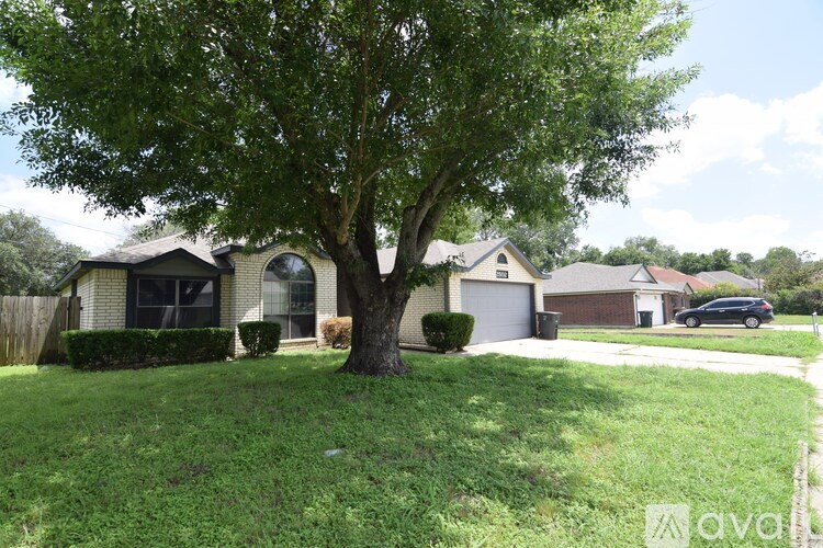 A white bathroom with a tub and a door.