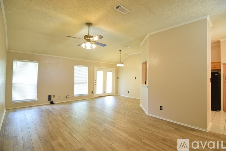 A room with wooden flooring and a window.