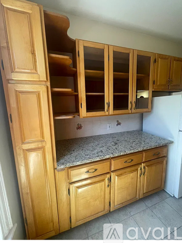 A kitchen with wooden cabinets and a granite countertop.