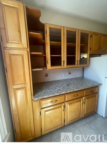 A kitchen with wooden cabinets and a granite countertop.